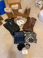 Complete lot of winter boots, slippers, two shawls, gloves, and earmuffs arranged on floor