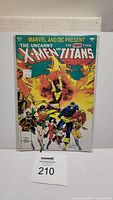 Front cover of the comic book showing Marvel and DC title, characters from X-Men and Teen Titans, priced $2.00.