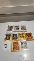 Photo showing all 9 basketball cards laid out on a white surface, cards include Larry Bird, Magic Johnson, Wilt Chamberlain, and Kareem Abdul-Jabbar.