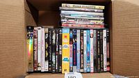 Top-down view of DVDs in a box showing 29 DVDs with visible titles including Black Dynamite and others.