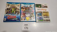 Three Nintendo game cases for Wii and Wii U displayed horizontally showing front cover artwork.