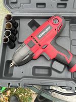 Eastvolt red and black impact wrench with four sockets in original molded plastic carry case.