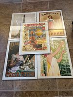Five retro posters arranged on floor, viewed from above, showing the overall lot.