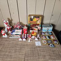 Full collection of Coca-Cola collectibles including polar bear figurines, toy trucks, roll-up posters, can, and collectible cards.