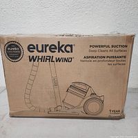 Sealed retail box showing Eureka Whirlwind branding and product illustration with suction claims.