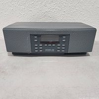 Front view of Henry Kloss Model 92 radio showing speaker grille, digital display and control buttons.