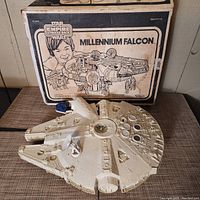 Front of original cardboard box with Star Wars Empire Strikes Back Millennium Falcon graphic alongside assembled playset top view