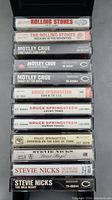 Photo of 12 cassette tapes featuring The Rolling Stones, Motley Crue, Bruce Springsteen, and Stevie Nicks.