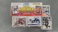 Original 1990 Score NHL Hockey Premier Edition card set box and protective card sleeves with individual cards visible.