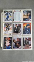 Front view of 9 hockey cards from 1990-91 Upper Deck series arranged in a 3x3 grid showing player images, statistics, and trophy cards.