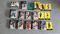 Image showing an arranged assortment of Parkhurst hockey cards in multiple stacks and single cards laid out, displaying the variety of player cards from the early 1990s series, including cards with yellow backs and black borders.