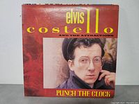 Front cover of Punch The Clock LP by Elvis Costello and The Attractions, showing minor wear.