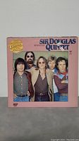 Sir Douglas Quintet album cover featuring band members posed in front of a pink background.