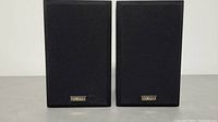 Pair of Yamaha speakers front view with fabric grille and Yamaha logo