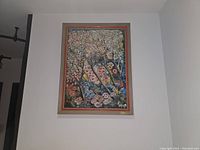 Full view of framed original oil painting by Erna A. Harm hanging on wall, 27" by 21"