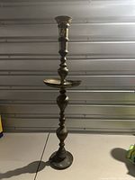 Full view of the Moroccan brass floor candle stand showing its height and overall shape