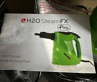 User guide with image of green H2O SteamFX Pro steam cleaner and branding