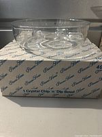 Crystal chip n dip bowl sitting on original box with Princess House branding, showing bowl top side and clear view of original packaging.