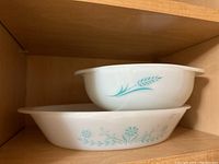 Side view of 1.5 qt Pyrex Blue Turquoise casserole dish with blue wheat and leaf pattern, showing shape and design