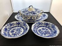 Overall view of the Johnson Brothers Blue Onion serving platter, casserole dish with lid, and two salad bowls arranged together