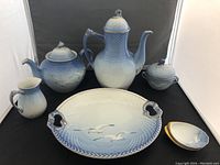 Coffee pot, teapot, creamer, sugar bowl, serving platter, oyster plate displayed