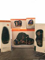 Five boxed Department 56 Halloween village accessories including tree, pumpkins, character, graveyard fence, and landscape set boxes.