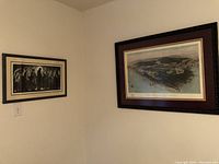 Both framed art pieces hanging on a wall at an angle, showing relative sizes and frames.