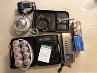 Top view of the lot showing the gas range, bottles of butane, butter warmers, and other cookware and appliances.