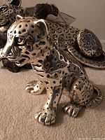 Front three-quarter view of the silver leopard cub statue showing detailing