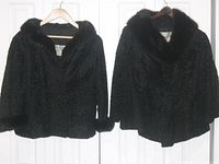 Photo showing two black vintage fur coats hanging on door, both medium size and needing buttons as per seller description.