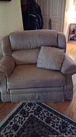 Grey fabric love seat recliner with cushioned back and removable pillow