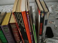 Photo showing spines of nine Time Life repair handbooks arranged side by side on a decorated cloth surface.