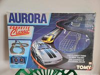 Front of original box showing Aurora Corvette Classic Turbo Car Race Set title and art with track and cars.
