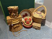 Full lot of 8 baskets and basket decor items grouped on tiled floor.