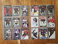 Photo showing all 18 Ottawa Senators hockey cards in protective sleeves, arranged in a grid, featuring rookies Kleven and Greig among others.