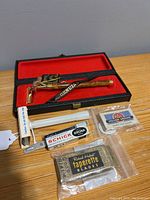 Vintage 24K gold electroplated razor in original case with assorted vintage disposable razor blades including Schick, Taparette, PAL, and Krona brands