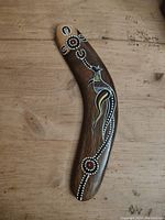 Front of the boomerang showing detailed Aboriginal-style kangaroo painting with dot art and circular patterns.
