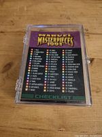 Back of one card showing the checklist of the 1993 Marvel Masterpieces 90 card base set with names and card numbers of characters.