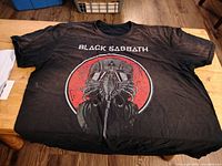 Front view of black Black Sabbath vintage t-shirt with gas mask graphic and text.