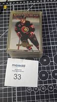 Stack of 1993 Donruss Rated Rookie hockey cards in plastic sleeves, showing the top card with player Alexandre Daigle in Ottawa Senators uniform.