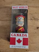 Front view of boxed Dudley Do-Right Canada Wacky Wobbler bobblehead showing the figure inside and Montreal Canadian flag graphics on the box.