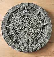 Front view of the circular Mayan calendar composite wall hanging showing detailed carvings and symbols.