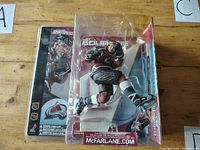 Front view of McFarlane Sports Picks NHL Ray Bourque Colorado Avalanche Chase figure in original packaging on wooden surface.