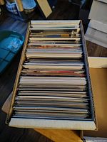 Top view of short box containing comic books packed upright in plastic sleeves.