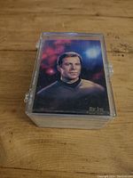 Stack of Star Trek 1993 Skybox Master Series trading cards with Captain Kirk on the front card, stored in a plastic protective case.