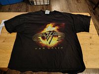 Front view of black VAN HALEN vintage t-shirt with logo and flame graphic