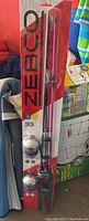 Zebco 33 fishing rod and reel combo in packaging shown hanging upright among other items