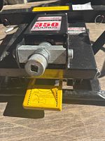Close-up photo showing the lifting mechanism with 350 lbs capacity label and yellow pedal for raise/lower operation