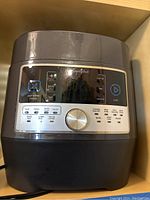 Front view of Pampered Chef multi cooker showing control panel and buttons.