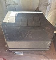 Closed black plastic Skil storage case for circular saw, showing exterior with 'SKIL' embossed on lid.